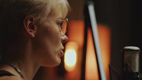 Female Podcast Host Talking into Microphone in Recording Studio