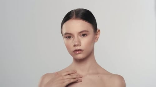 Beautiful Female Model Touching Her Smooth Skin and Looking at the Camera