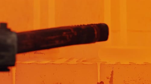 Metal parts inside an industrial furnace during forging process. Manufacturing of jet turbine parts