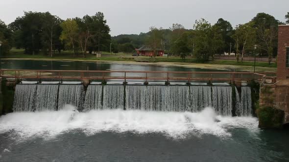 dam showing both the slow moving water side as well as the rushing ...
