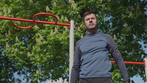 Man Stretching Before Outdoor Workout in Park Athlete Prepares for Training