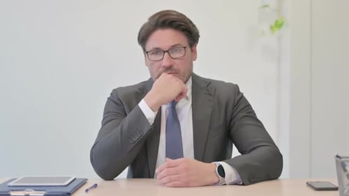 Retrato de um empresário pensativo de meia idade pensando no escritório