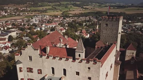 Aerial Flight Above an Old Castle in a Small Town in Austria