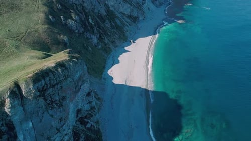Aerial Panoramic View of the Rocky Cliffs Seaside and Waves are Crashing to the Coast Beautiful