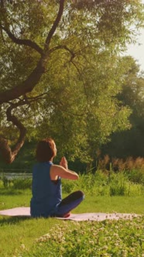 Woman Meditates in Nature on a Sunny Day