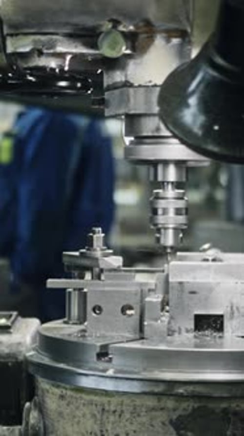 Precision lathe operator in action at industrial workshop