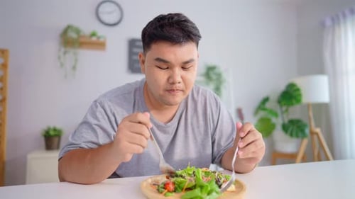 Man Enjoying a Healthy Salad at Home