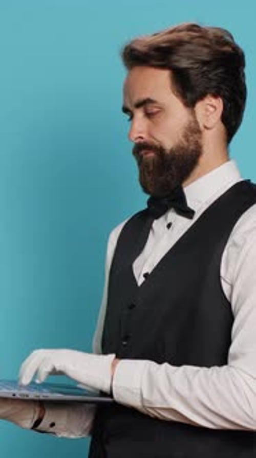 Vertical Video Hotel Porter Working on Laptop