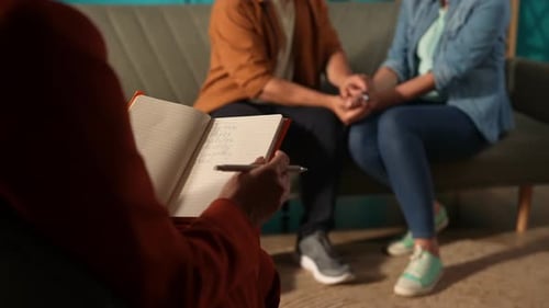 Couple Talking with Therapist in Indoor Setting