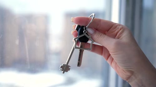 Woman Holding House Keys Near Window
