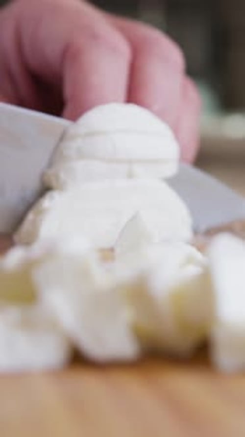 Chef Cuts Buffalo Mozzarella Cheese On A Wooden Cutting Board