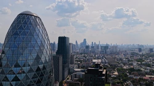 Modern Architectural Building with Glass Facade of Pearl Bangkok Building Towering Over Sprawling