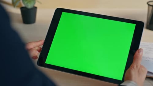 Person Using Tablet With Green Screen Display