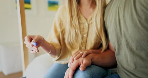 Loving Couple Holding Pregnancy Test Together Indoors