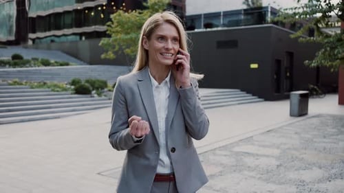 Attractive Woman Having Conversation on Smartphone on Street