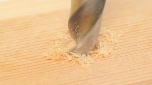 El movimiento de un taladro que perfora madera