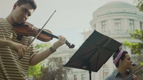 Young Performers Playing Classical Music Instruments in Park
