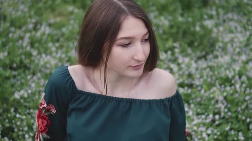 Young Woman in Field of Flowers Contemplative Mood