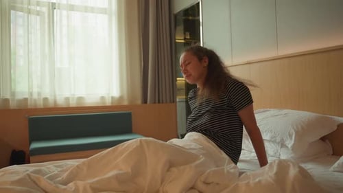 Woman in Bed Wakes up with Headache