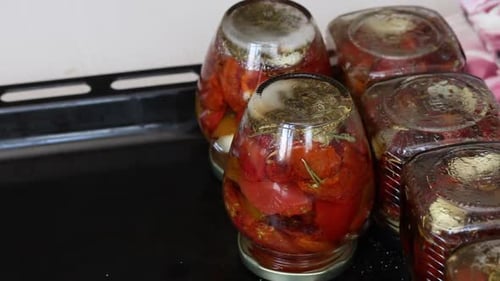 Jars of Canned Tomatoes with Herbs and Garlic