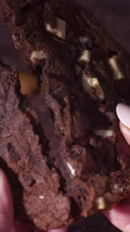 Close Up Hands Breaking Soft Cookie With Almond Pieces