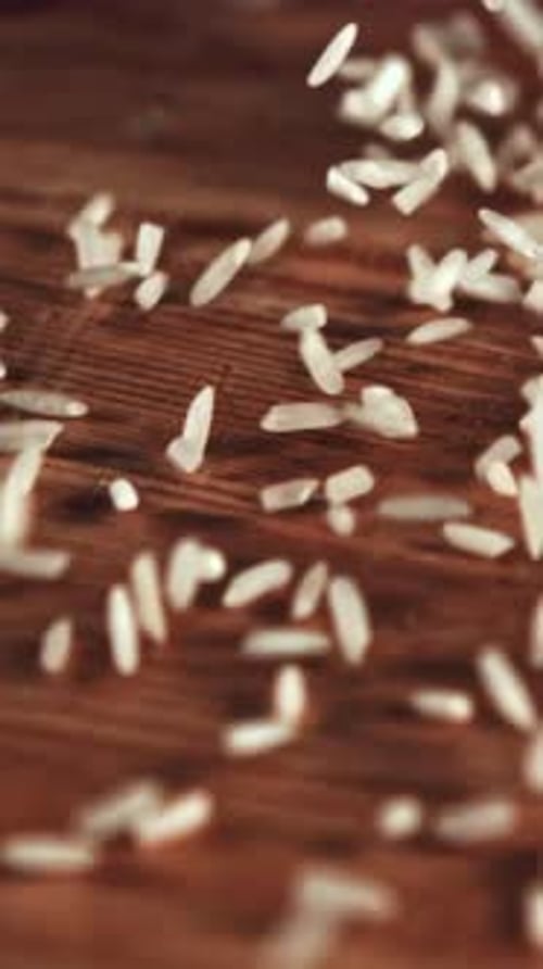 Uncooked Rice is Scattered on the Table and Rotated Filmed on a Highspeed Camera at 1000 Fps