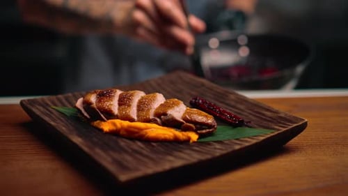 close-up of a dish pieces of juicy roasted duck with puree on a plate Asian cuisine restaurant