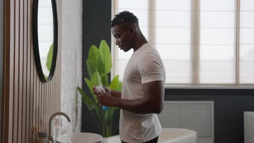 African American Man Cleaning Teeth Rinse with Dental Care Product Mouth Hygiene at Bathroom Rinsing