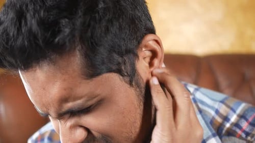 Young Man Having Ear Pain Touching His Painful Ear