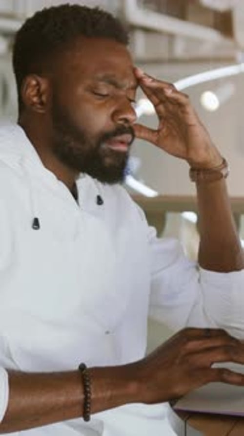 Dedicated and Focused Professional Engaged in Work Within a Modern Office Environment