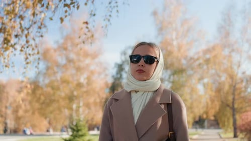Autumn Girl in Fashionable Attire Confident Lady Enjoying Park Walk in Fall Elegant Woman with