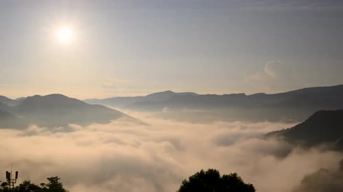 The orange-red glow of the sunrise illuminated the raging sea of clouds.
