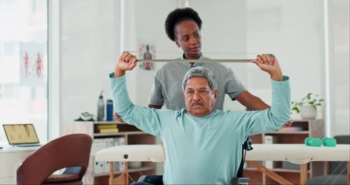 Patient Exercising With Physical Therapist in Clinic