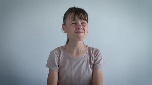 Girl Covers Ears in Discomfort Inside Studio