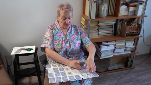 Femme âgée jouant à un jeu de cartes de solitaire à bord