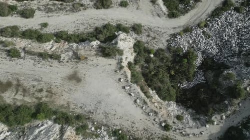 Quarry filling with green water, top down aerial view