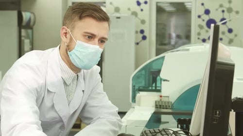 Young Scientist Working on Computer in a Lab