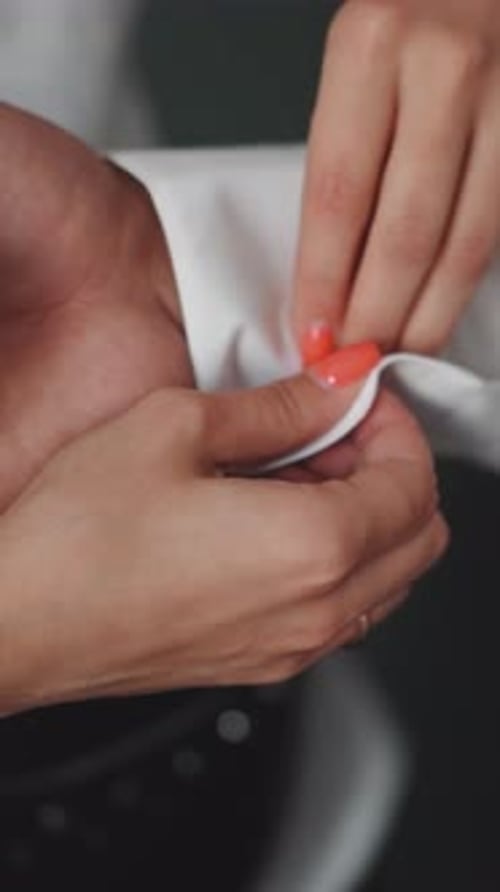 Assistant Buttons Shirt Cuff Preparing Male Model for Shoot