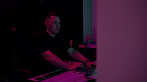 professional sound recording studio sound engineer or music producer sitting at the remote control