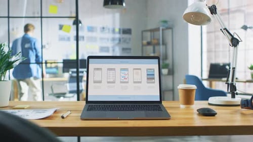 Laptop on the Desk in the Office Shows Screen with Mobile Phone Application Design, Software UI Dev