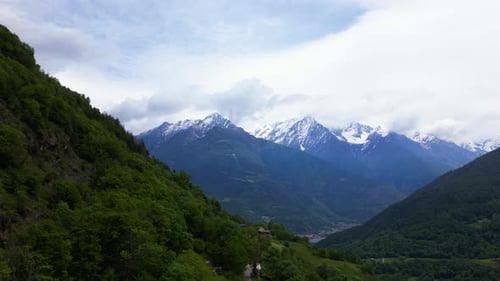 Alpine Mountain Range Overlooking Vico Edolo Valley With Forested Slopes