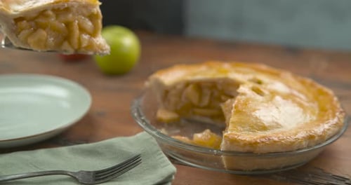 Big Slice Of Apple Pie Placed In A Pastel Blue Plate With A Palette Knife, On A Wood Table. Close...