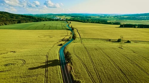Car Driving Along Curvy Rural Road Black Sedan Moving Under Sunny Weather Automobile Cruising