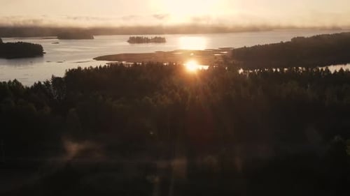 Sunrise in Finland at the lake with fog