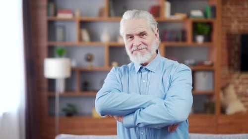 Senior Man Smiling with Arms Crossed Indoors