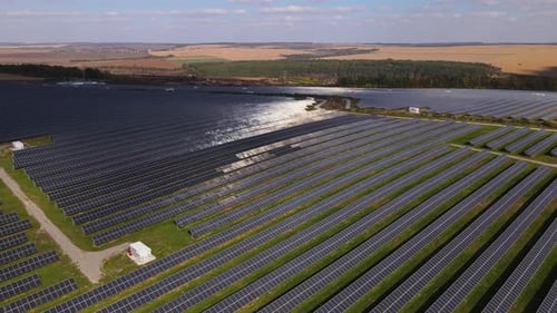 Aerial Panoramic View of the Large Power Farm Station with Solar Panels Renewable Energy Located in