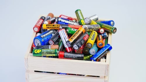 Used Batteries in a Wooden Crate