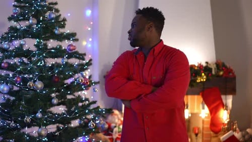 Portrait of Satisfied African American Young Man Crossing Hands Looking at Camera with Confident