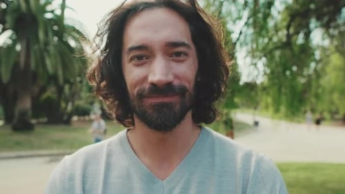 Close up, young smiling man looking at camera
