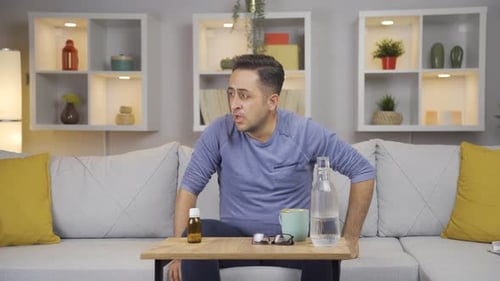 Man Rubbing Stomach Suffering from Painful Aches